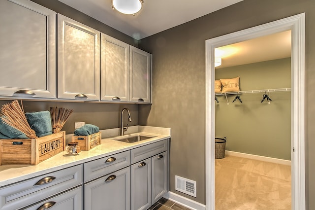 interior space featuring sink and light colored carpet