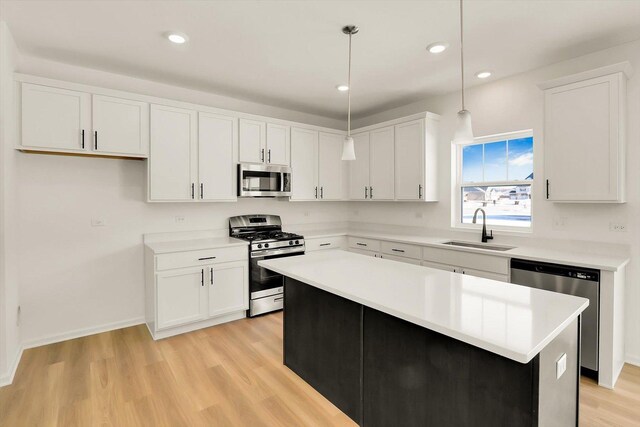 kitchen with light stone countertops, dark hardwood / wood-style flooring, a kitchen island, and pendant lighting