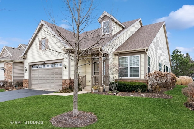 view of front of house with a garage and a front lawn