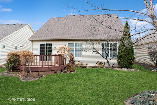 rear view of property with a lawn and a wooden deck