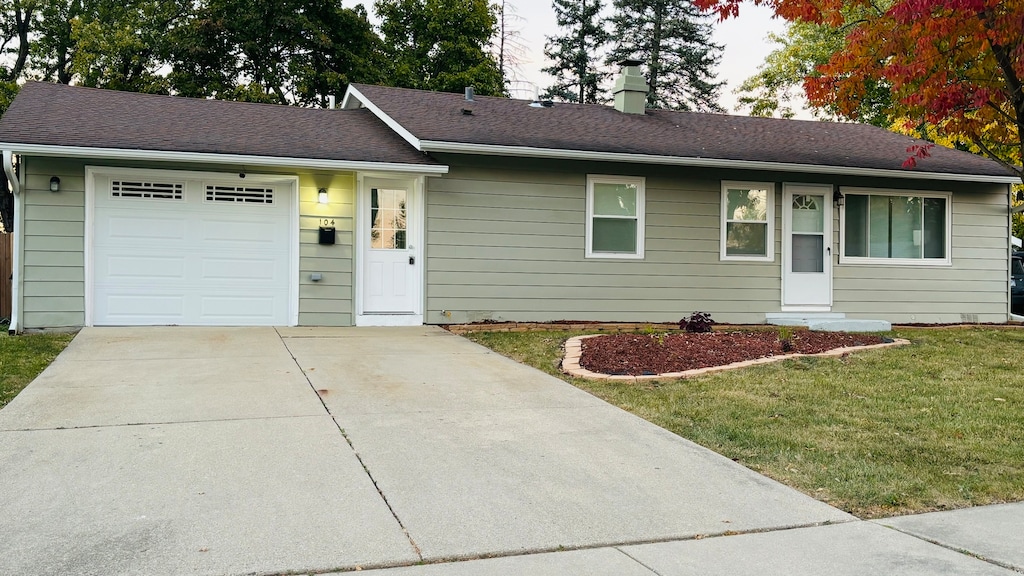 single story home featuring a front yard and a garage