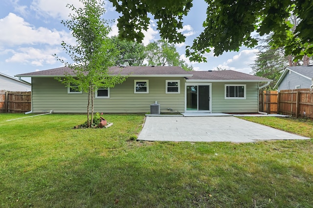 back of house featuring a lawn, central air condition unit, and a patio