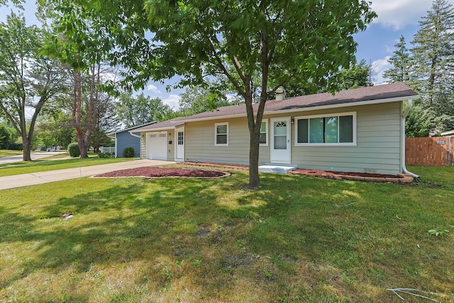 ranch-style home with a garage and a front lawn