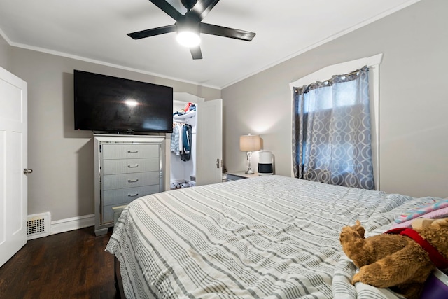 bedroom with dark hardwood / wood-style flooring, ceiling fan, a closet, and crown molding