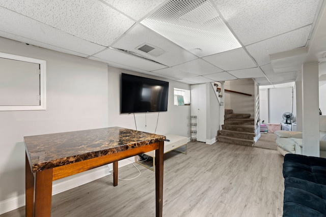 recreation room featuring a drop ceiling and hardwood / wood-style floors