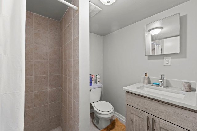 bathroom with vanity, toilet, and curtained shower