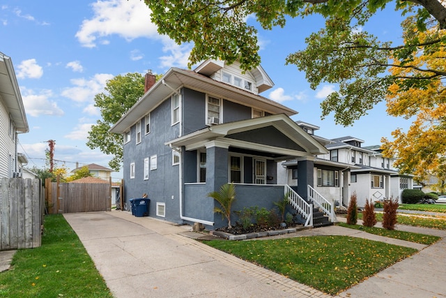 view of front of property featuring covered porch and a front lawn