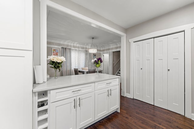 kitchen with white cabinets, dark hardwood / wood-style floors, and hanging light fixtures