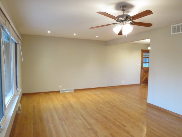 spare room with light hardwood / wood-style flooring and ceiling fan