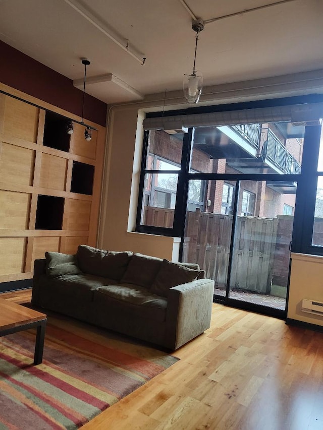 living room with hardwood / wood-style floors and a healthy amount of sunlight