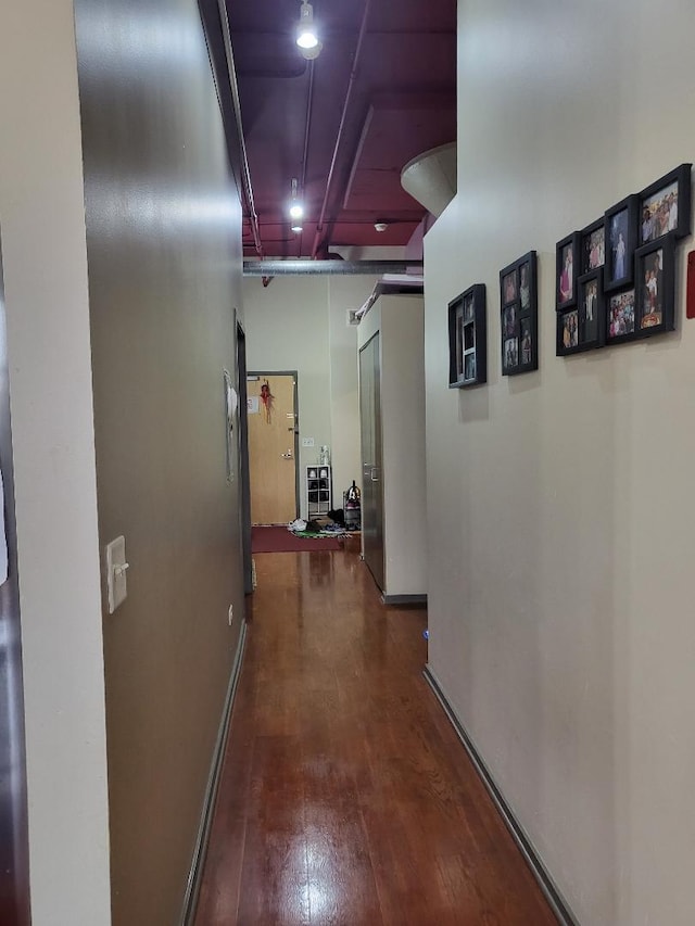 corridor with dark hardwood / wood-style floors