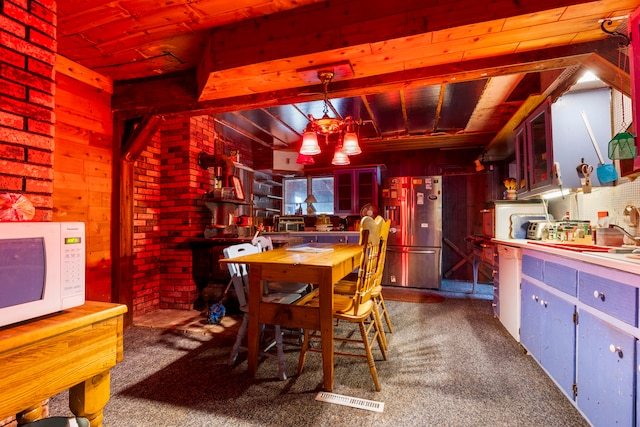 dining room featuring wooden walls, carpet floors, and wood ceiling