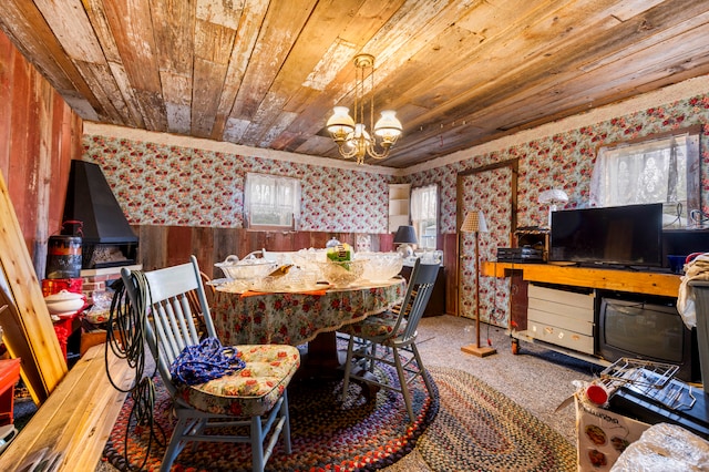 dining area with a notable chandelier, wood walls, and wooden ceiling