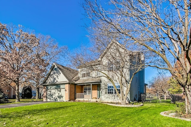 front of property featuring a front lawn, a porch, and a garage