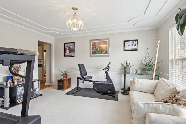 workout room with a chandelier, carpet floors, a wealth of natural light, and crown molding