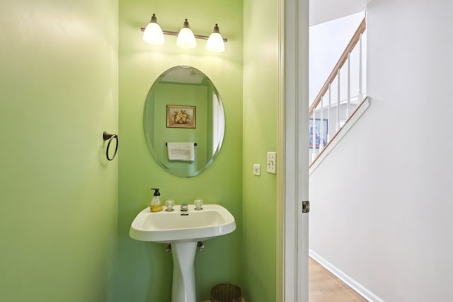 bathroom with hardwood / wood-style flooring and sink