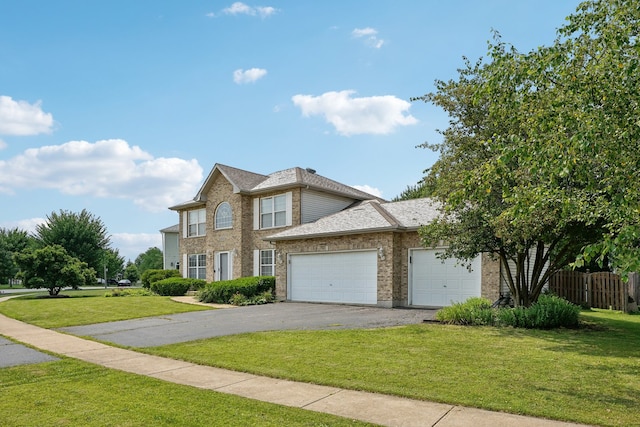 view of front of property with a garage and a front lawn