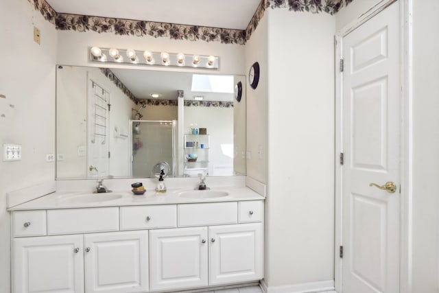 bathroom with vanity and a shower with door