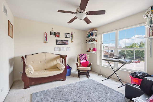 sitting room with ceiling fan and light carpet