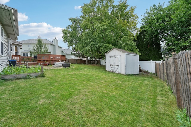 view of yard featuring a storage unit and a deck