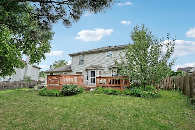 back of property featuring a yard and a deck