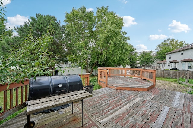 wooden terrace featuring a grill