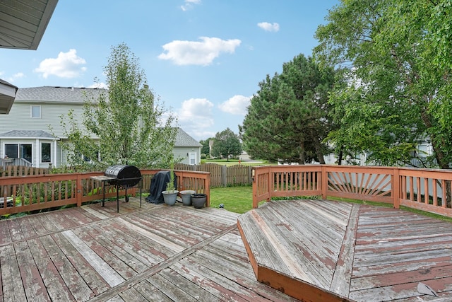 wooden deck with a grill