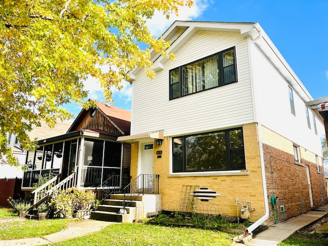 view of front of home with a sunroom