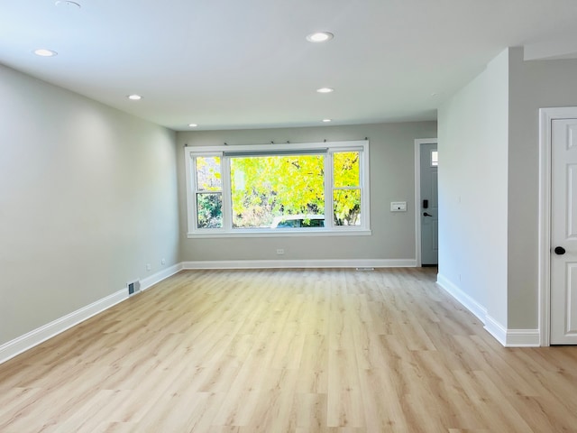 spare room featuring light wood-type flooring