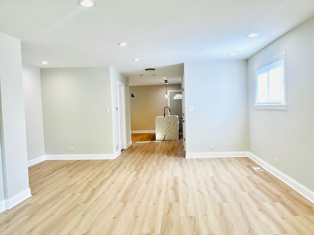 spare room featuring light wood-type flooring