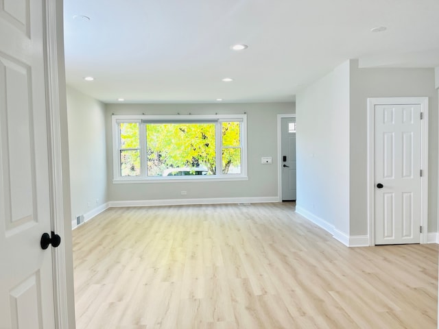 unfurnished room with light hardwood / wood-style flooring