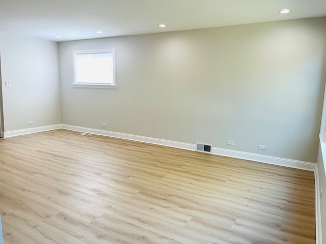 unfurnished room with light wood-type flooring