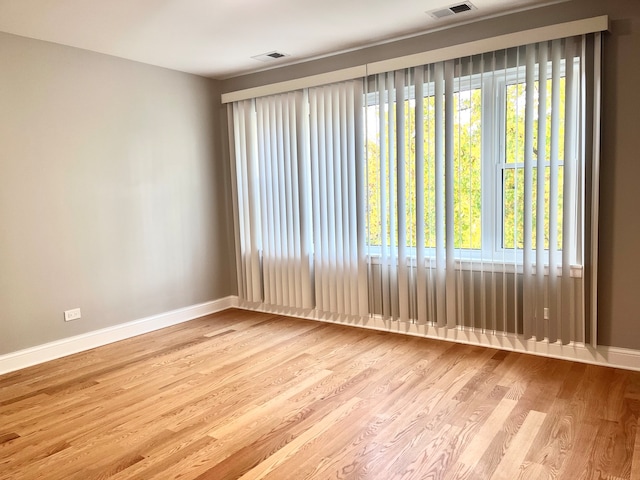 unfurnished room with light wood-type flooring