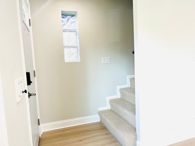 stairway featuring hardwood / wood-style flooring