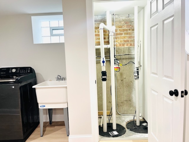 laundry room with wood-type flooring and washer / clothes dryer