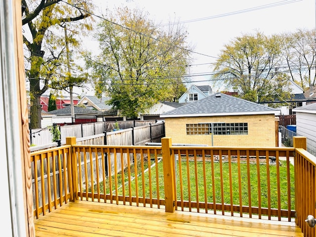 wooden deck featuring a lawn