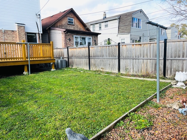 view of yard featuring central air condition unit and a deck