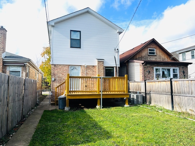 back of house with a lawn, a wooden deck, and cooling unit