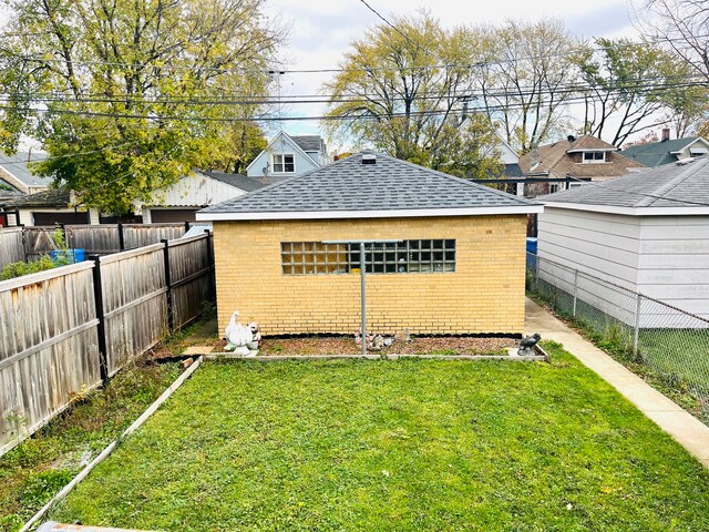 back of property featuring a lawn