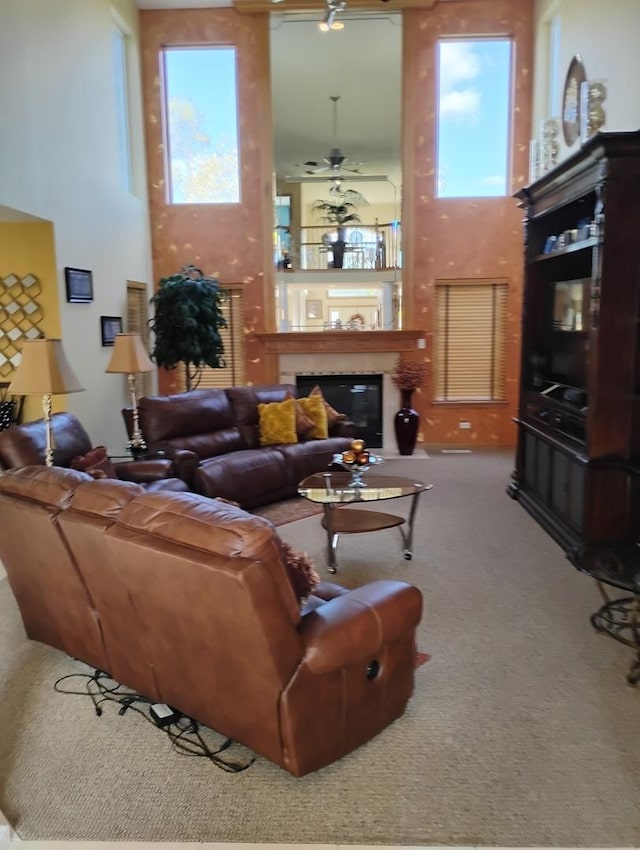 carpeted living room with ceiling fan