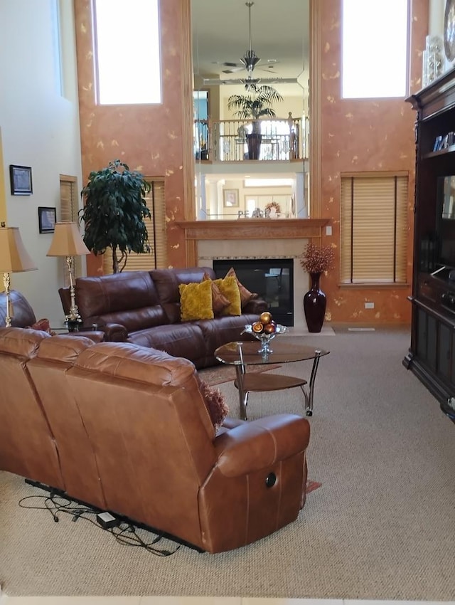 carpeted living room with ceiling fan