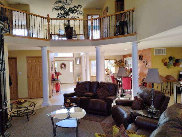 living room featuring a towering ceiling and light tile patterned flooring