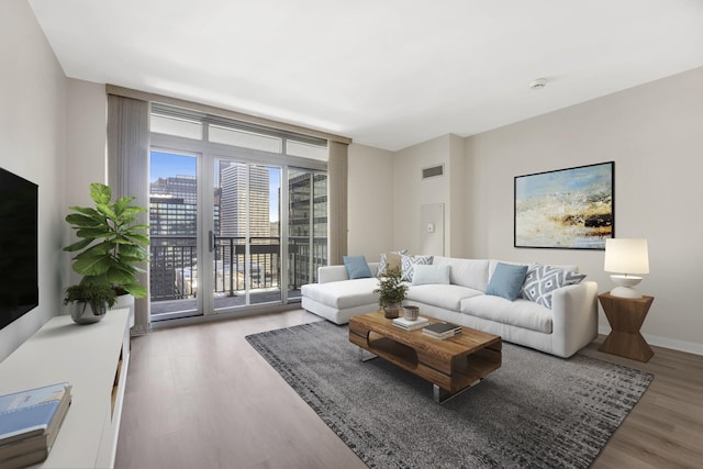 living room featuring expansive windows and hardwood / wood-style floors