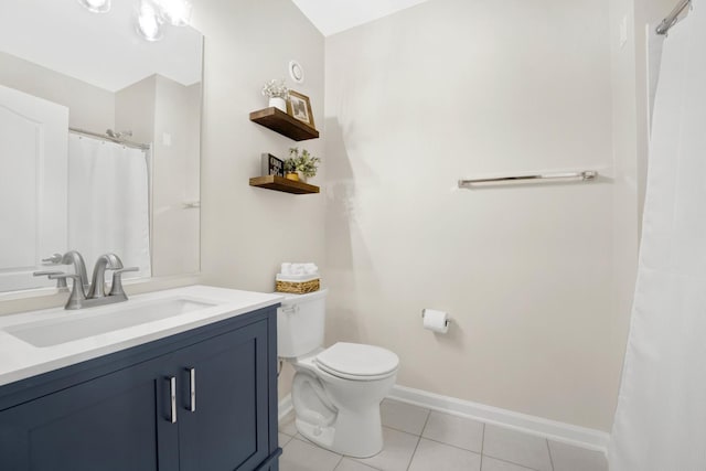 bathroom with vanity, toilet, and tile patterned flooring