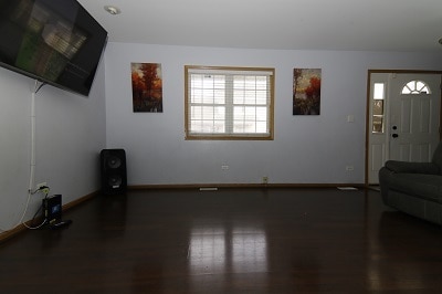 unfurnished living room featuring dark hardwood / wood-style floors