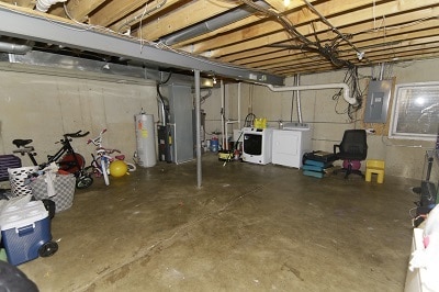 basement with washer and dryer, electric panel, and water heater