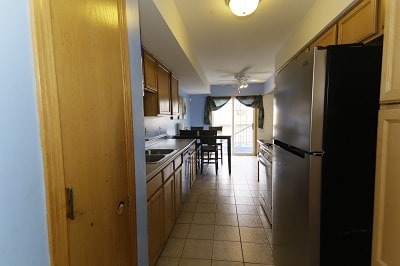 kitchen with ceiling fan, light tile patterned flooring, sink, and stainless steel appliances