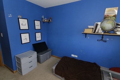 bedroom featuring light carpet