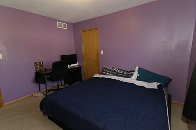 bedroom featuring light carpet