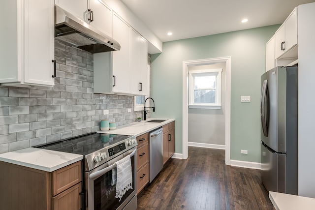 kitchen with white cabinets, stainless steel appliances, and tasteful backsplash